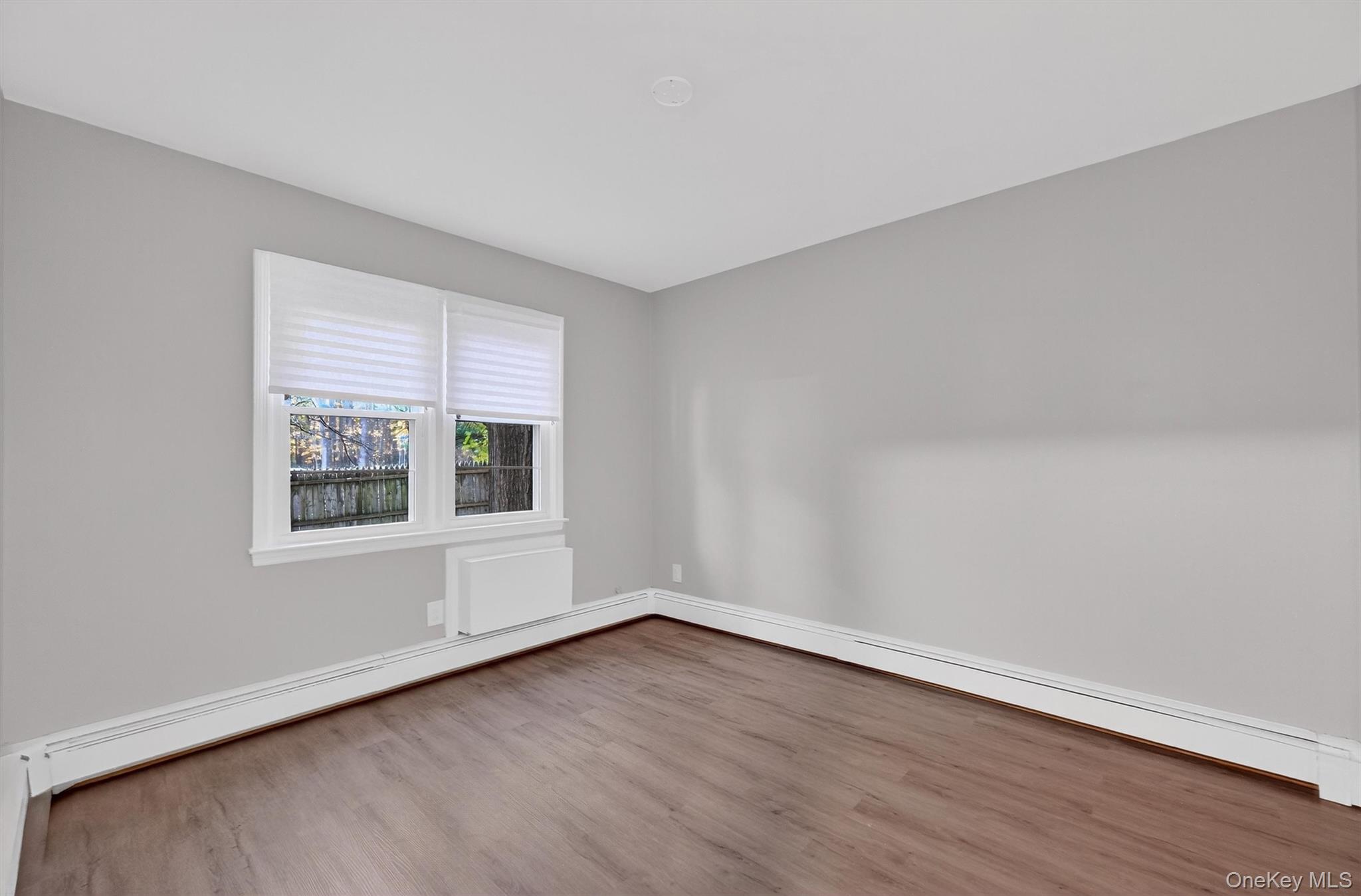 2710 South Road, Unit B5 Poughkeepsie, NY 12601 - Photo 14 of 19 a view of an empty room with wooden floor and a window