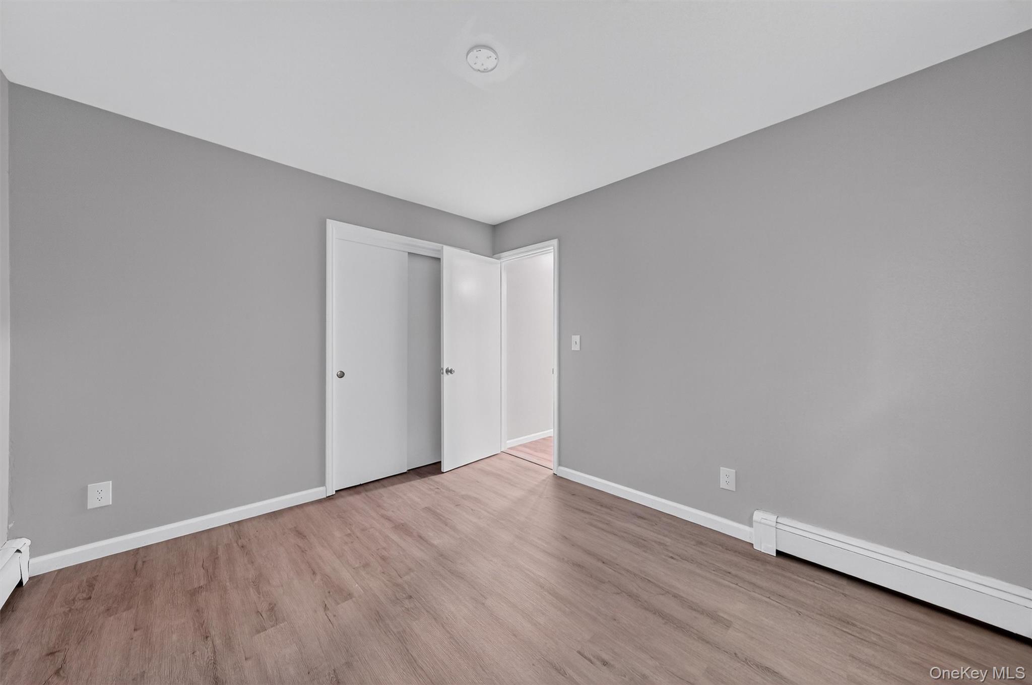 2710 South Road, Unit B5 Poughkeepsie, NY 12601 - Photo 15 of 19 a view of an empty room with wooden floor