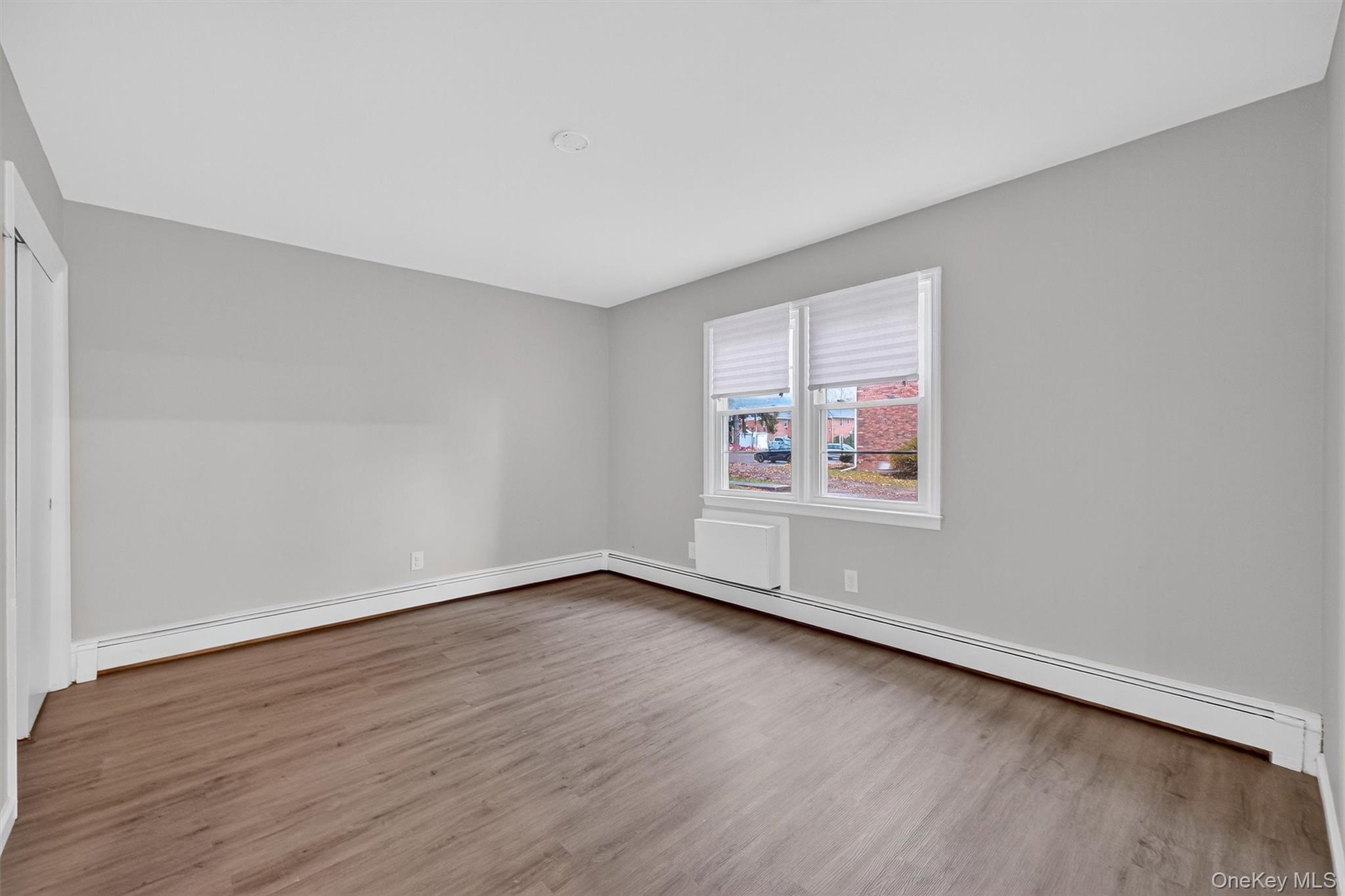 2710 South Road, Unit B5 Poughkeepsie, NY 12601 - Photo 16 of 19 an empty room with wooden floor and windows