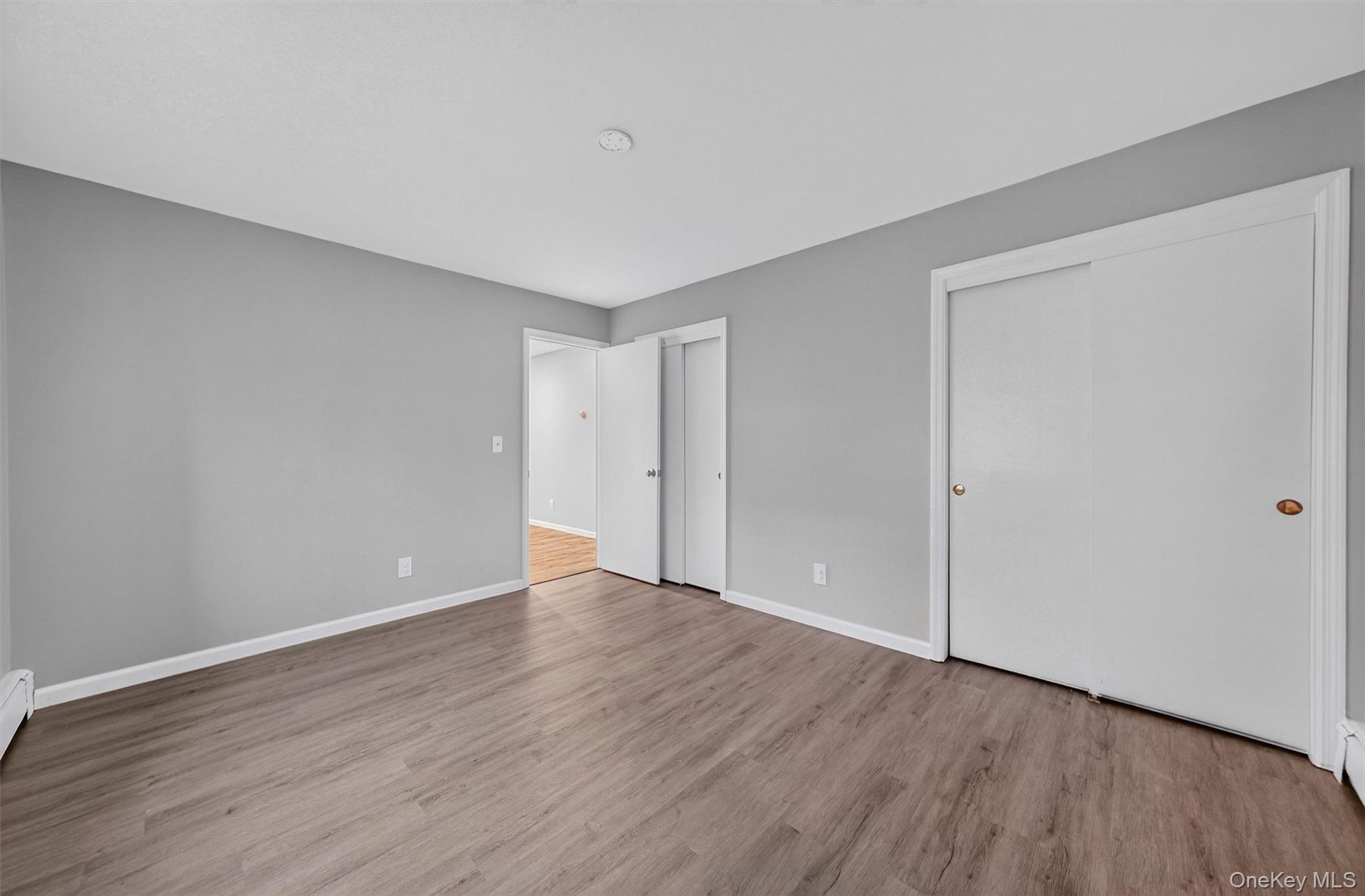 2710 South Road, Unit B5 Poughkeepsie, NY 12601 - Photo 17 of 19 a view of an empty room with wooden floor