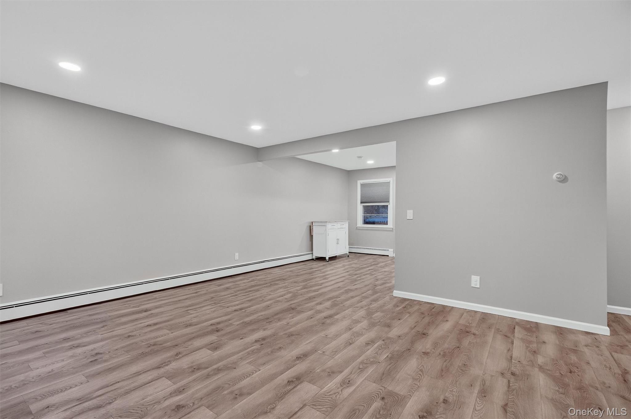 2710 South Road, Unit B5 Poughkeepsie, NY 12601 - Photo 2 of 19 a view of an empty room with wooden floor and a window