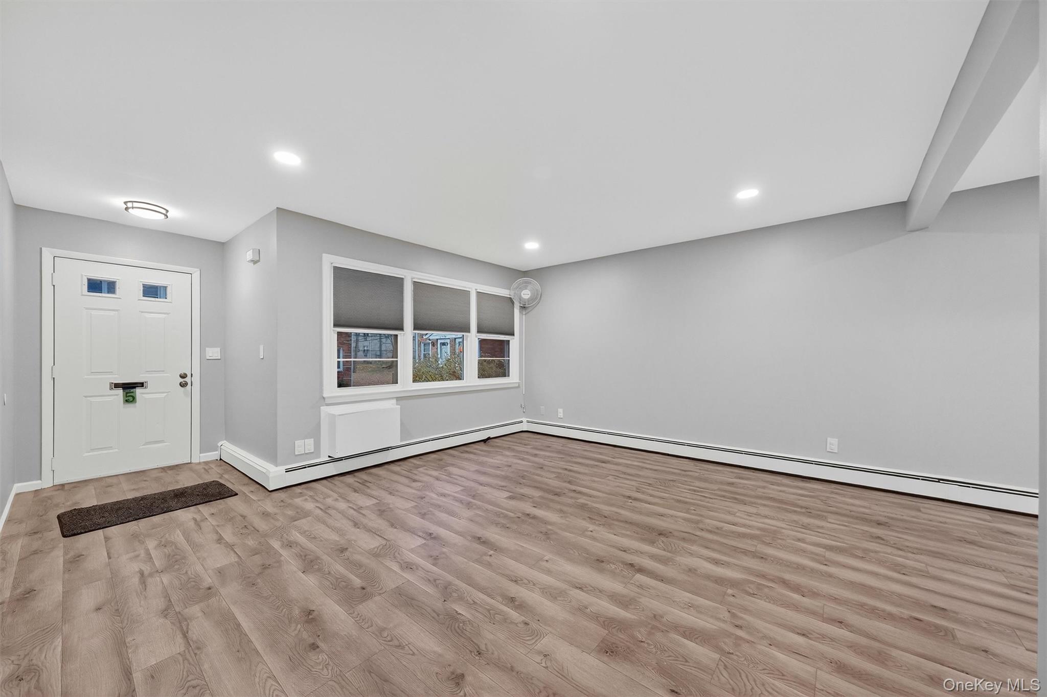 2710 South Road, Unit B5 Poughkeepsie, NY 12601 - Photo 5 of 19 a view of an empty room with wooden floor and a window