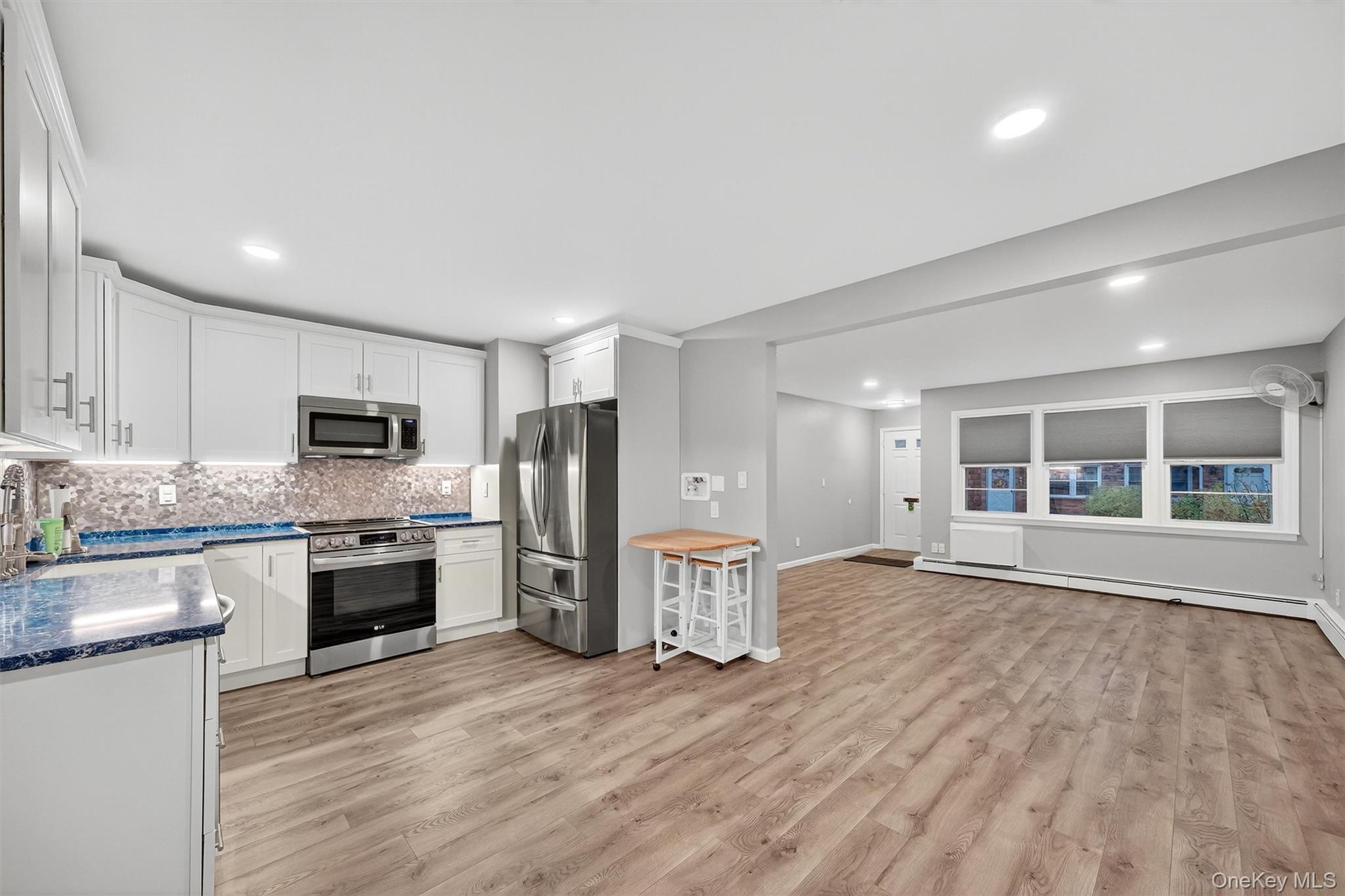 2710 South Road, Unit B5 Poughkeepsie, NY 12601 - Photo 7 of 19 a large kitchen with stainless steel appliances granite countertop a stove and a refrigerator