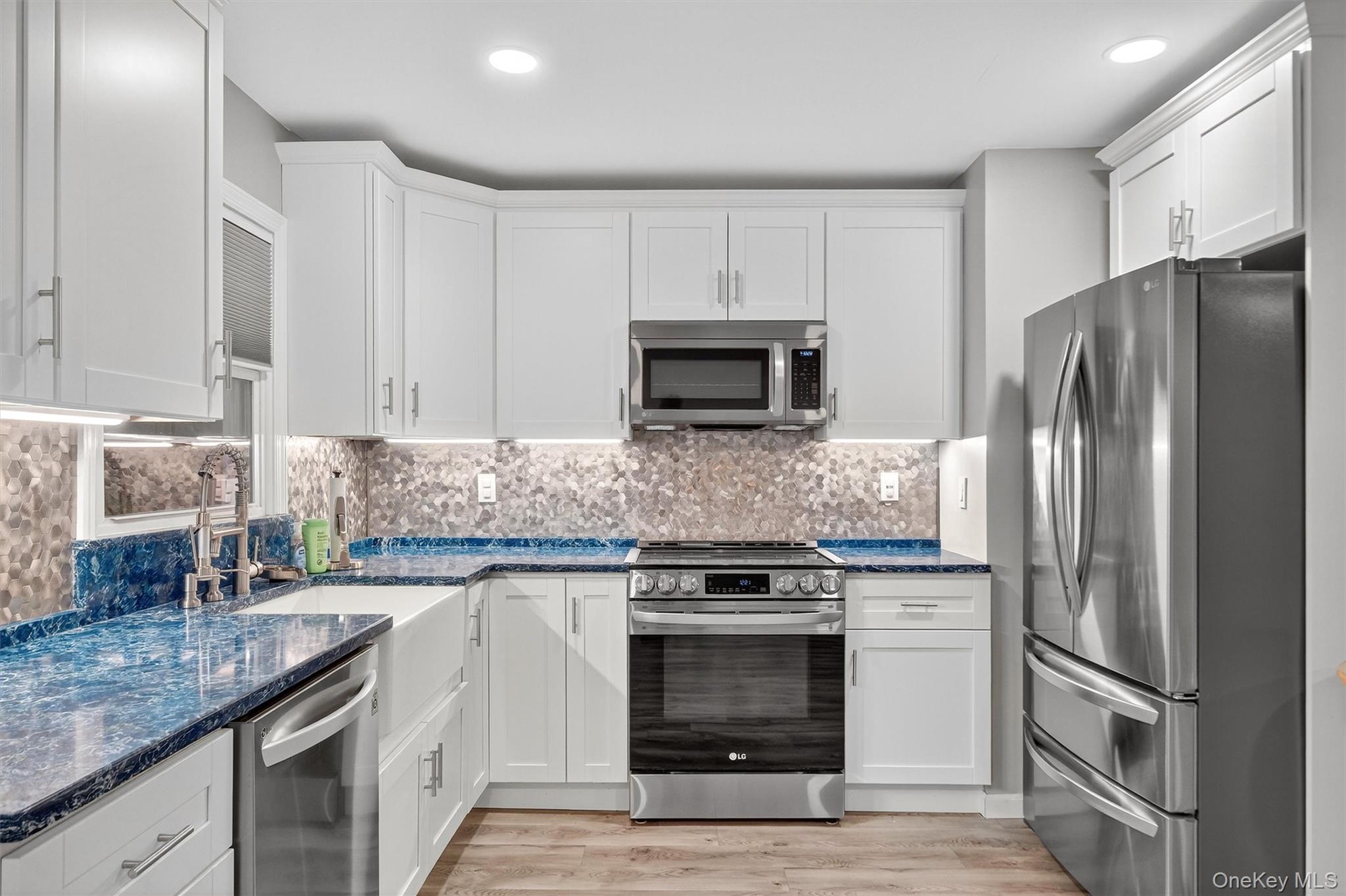 2710 South Road, Unit B5 Poughkeepsie, NY 12601 - Photo 8 of 19 a kitchen with granite countertop a refrigerator stove and microwave