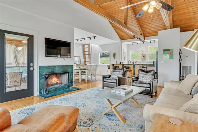 a open dining room with stainless steel appliances kitchen island granite countertop a table chairs stove and sink