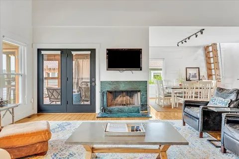 a dining table chairs next to a window