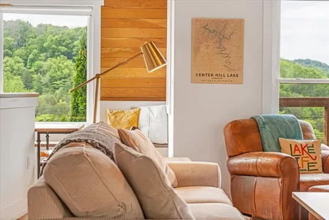 a dining room with furniture a chandelier and wooden floor