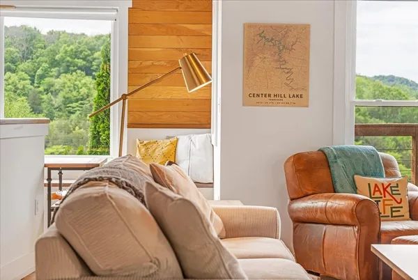 a dining room with furniture a chandelier and wooden floor