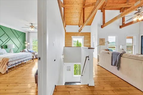 a dining area with stainless steel appliances a dining table and chairs with wooden floor