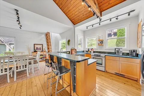 a dining room with furniture and a floor to ceiling window