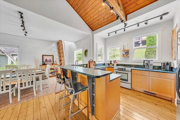 a dining room with furniture and a floor to ceiling window