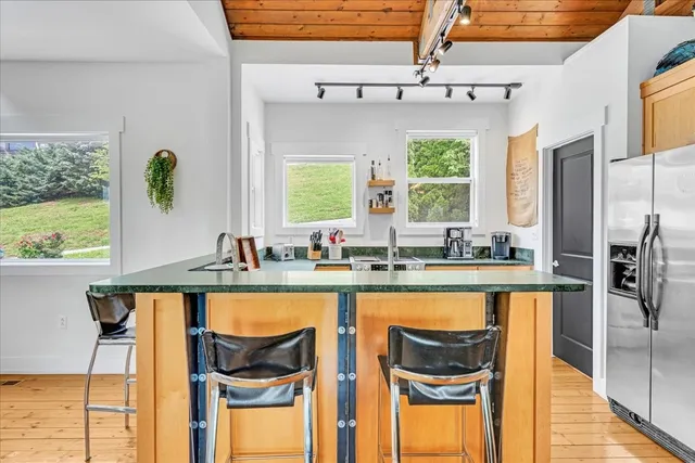 a bed sitting in a bedroom next to a window