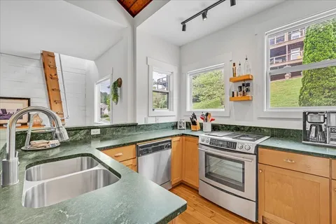 a bedroom with a bed and a large window