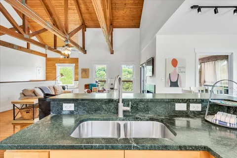 a spacious bedroom with a bed a table and chair