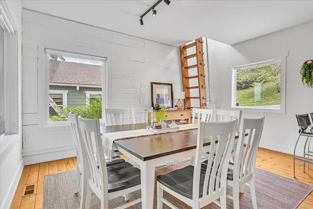 a large white bed in a room next to a window