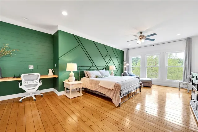 a bedroom with a bed couch and a window