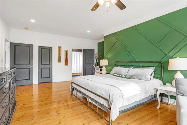 a bedroom with a bed and large window