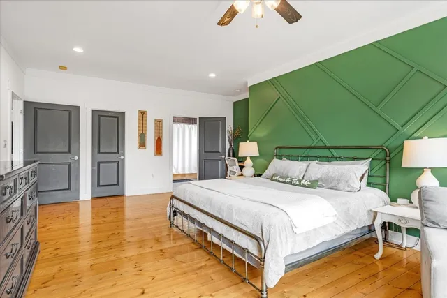 a bedroom with a bed and large window