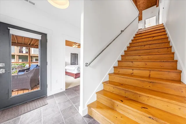 an aerial view of a house with a yard and lake view