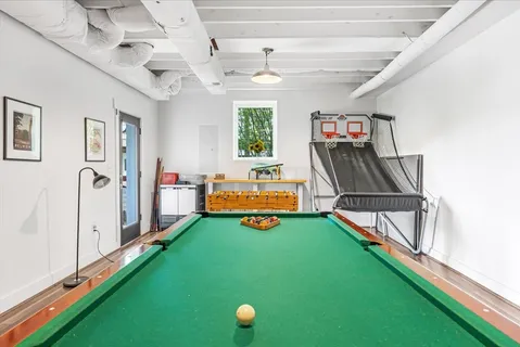 a view of a yard with plants and a fountain