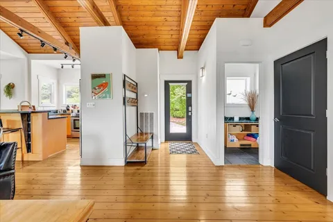 a bedroom with furniture and a wooden floor