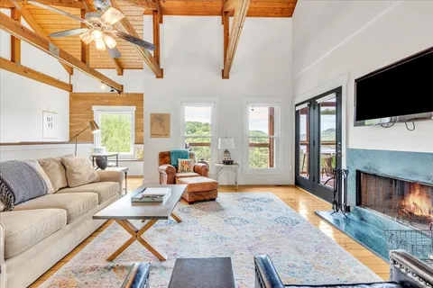 a living room with furniture fireplace and flat screen tv