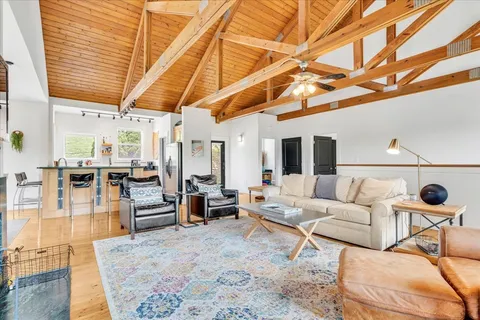 a view of a bedroom with furniture and a window