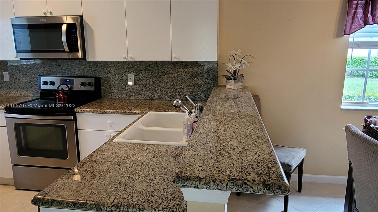 Baywinds West Palm Beach, FL 33411 - Photo 17 of 38 a kitchen with a stove and a microwave