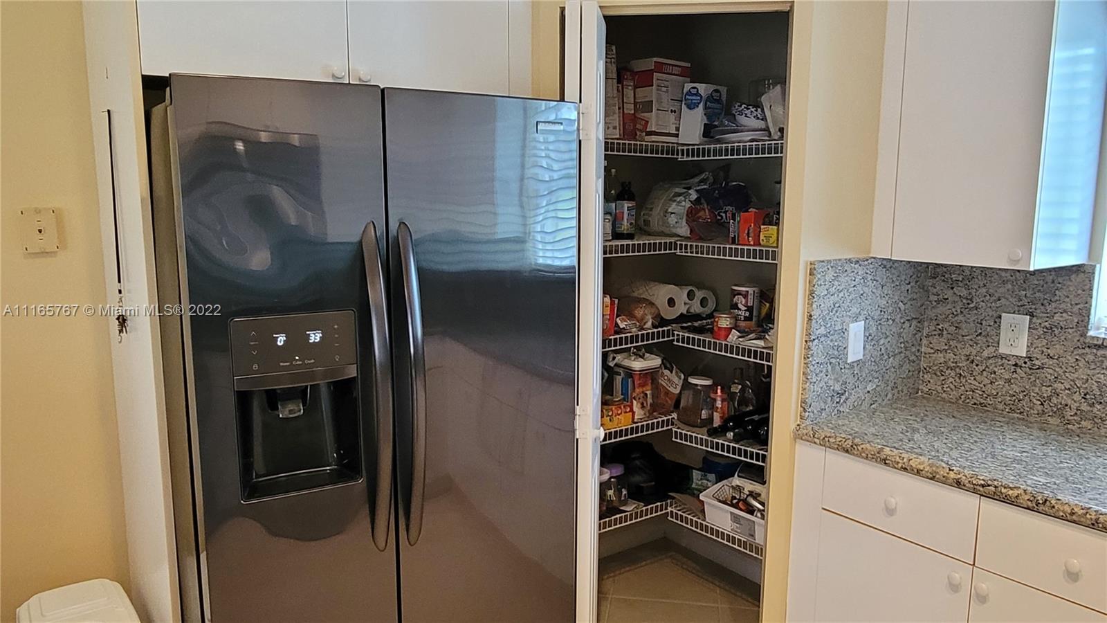 Baywinds West Palm Beach, FL 33411 - Photo 18 of 38 a kitchen with a refrigerator and cabinets
