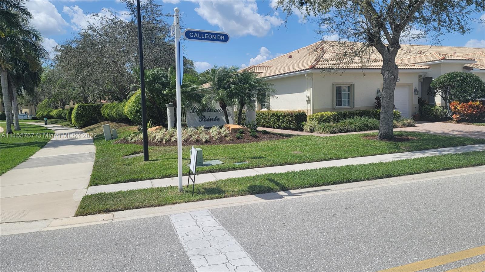 Baywinds West Palm Beach, FL 33411 - Photo 2 of 38 a view of a house with a yard and tree s