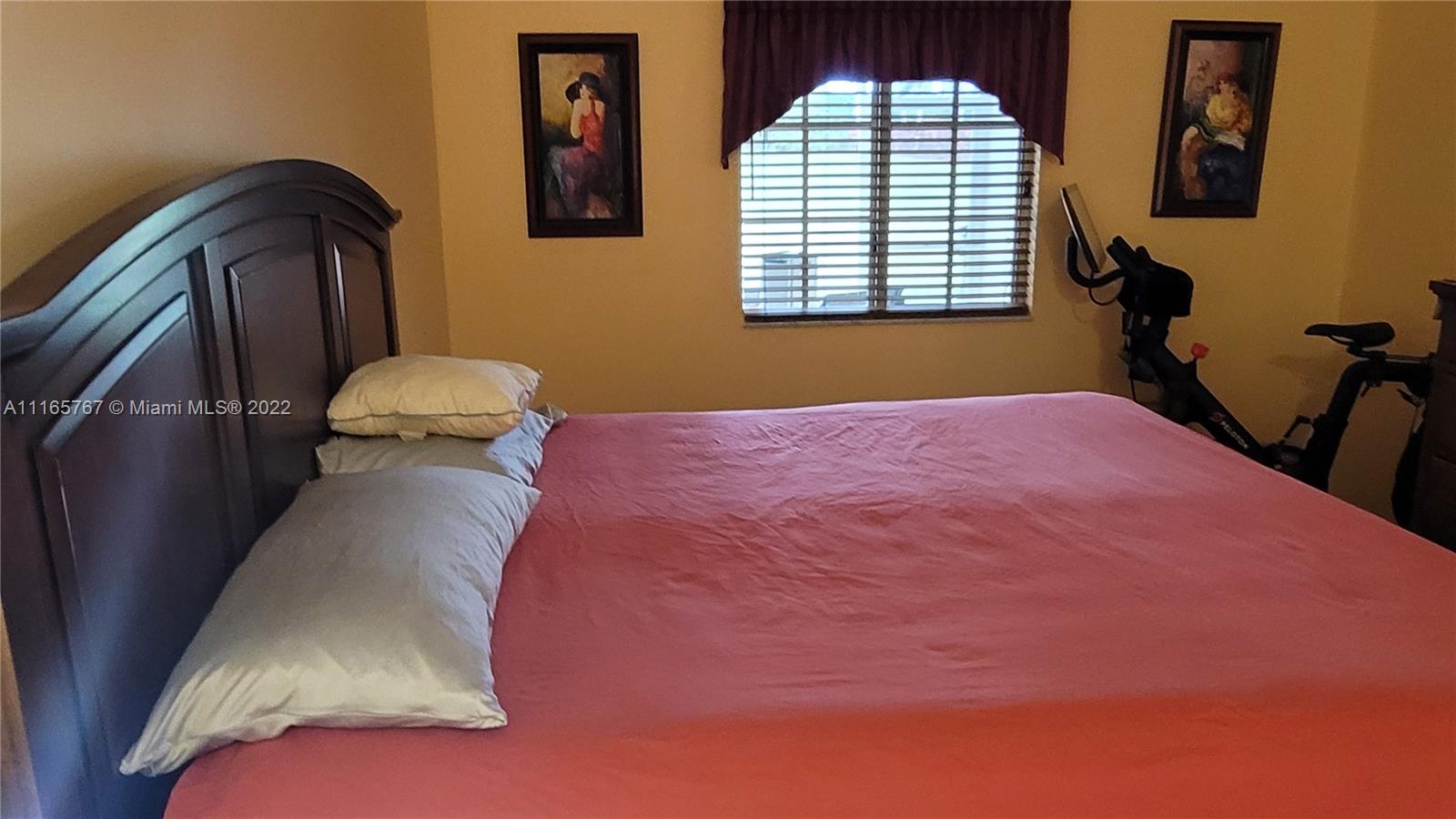 Baywinds West Palm Beach, FL 33411 - Photo 21 of 38 a bedroom with a bed and a chandelier