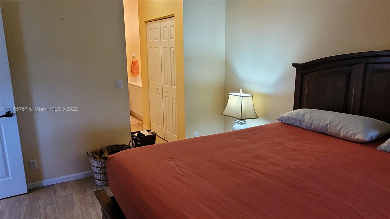 Baywinds West Palm Beach, FL 33411 - Photo 22 of 38 a bedroom with a bed and wooden floor