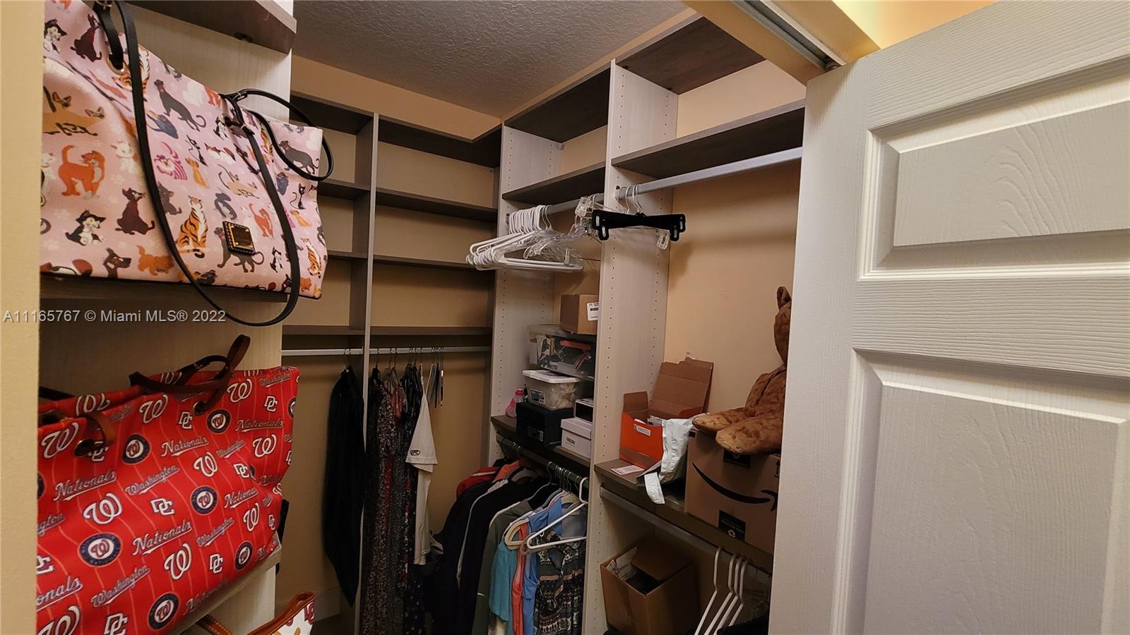 Baywinds West Palm Beach, FL 33411 - Photo 24 of 38 a view of walk in closet with clothes and shoes