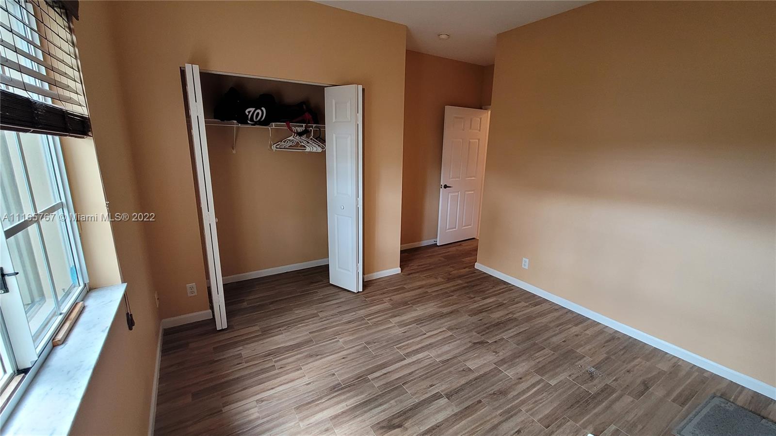 Baywinds West Palm Beach, FL 33411 - Photo 31 of 38 an empty room with wooden floor and a fireplace