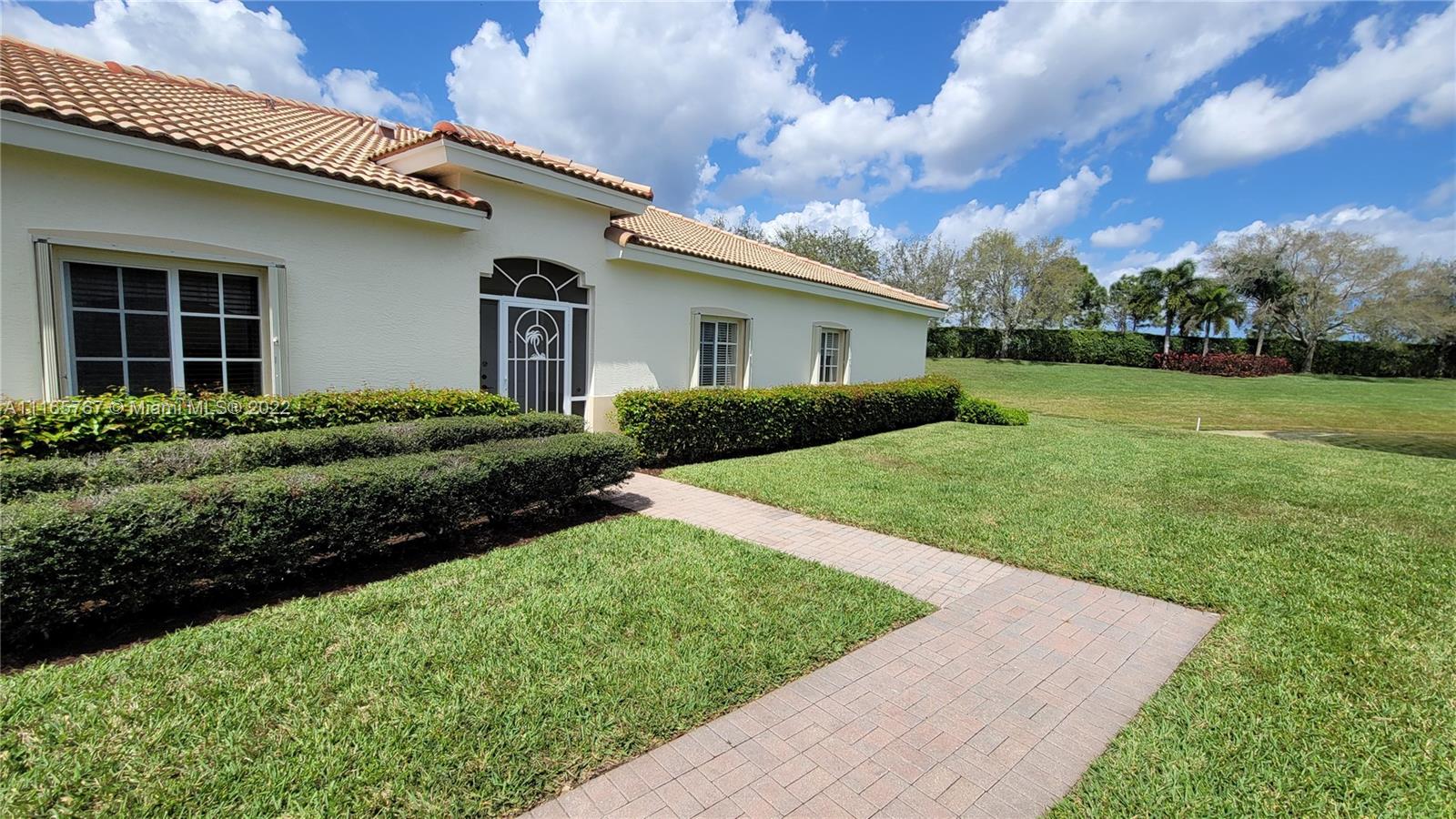 Baywinds West Palm Beach, FL 33411 - Photo 5 of 38 a front view of a house with garden