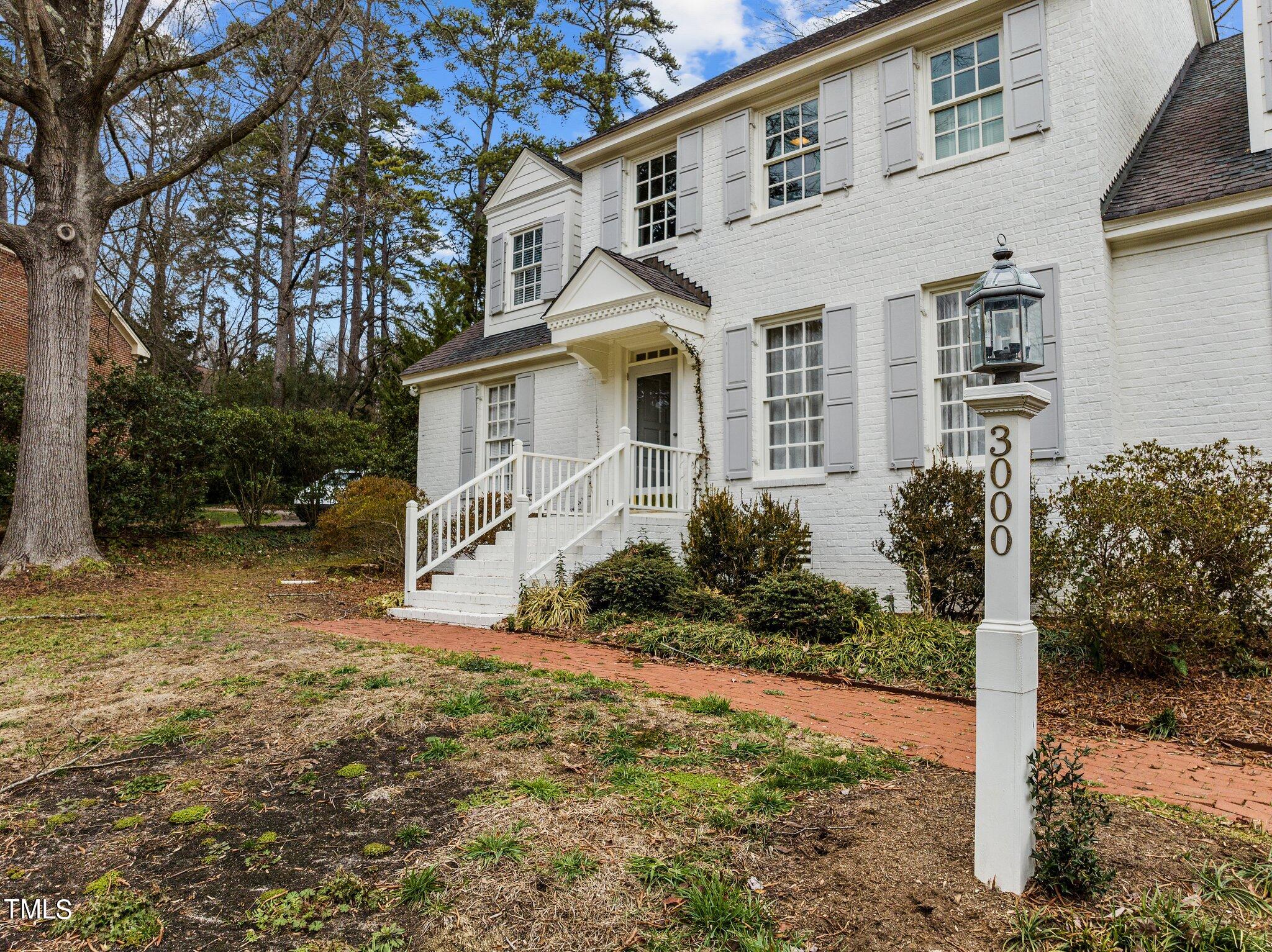 3000 Woodgreen Drive Raleigh, NC 27607 - Photo 3 of 55 a front view of a house with a yard and garage