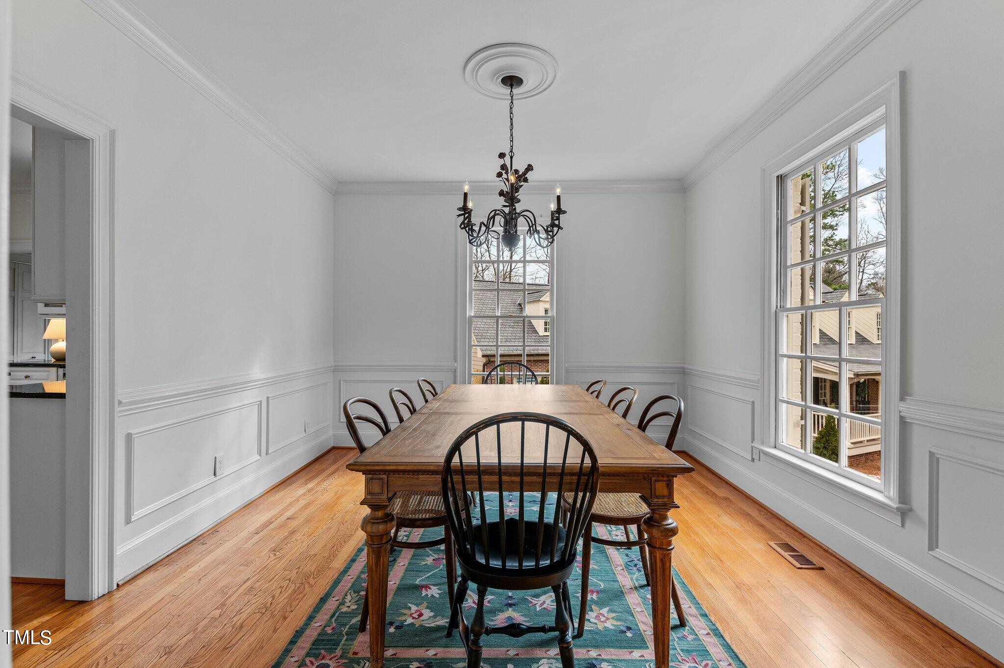 3000 Woodgreen Drive Raleigh, NC 27607 - Photo 8 of 55 a view of a dining room with furniture window and wooden floor