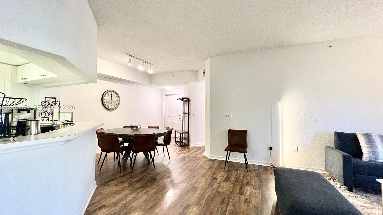 2727 Anzio Court, Unit 106 Palm Beach Gardens, FL 33410 - Photo 7 of 43 a view of a dining room with furniture and wooden floor