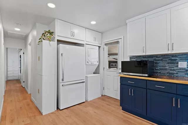 a kitchen with stainless steel appliances a refrigerator sink and cabinets