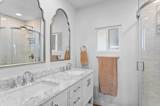 a bathroom with a double vanity sink and a mirror