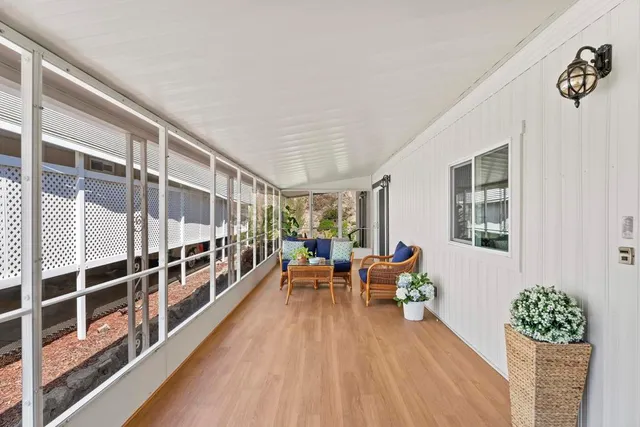 a living room with furniture windows and wooden floor