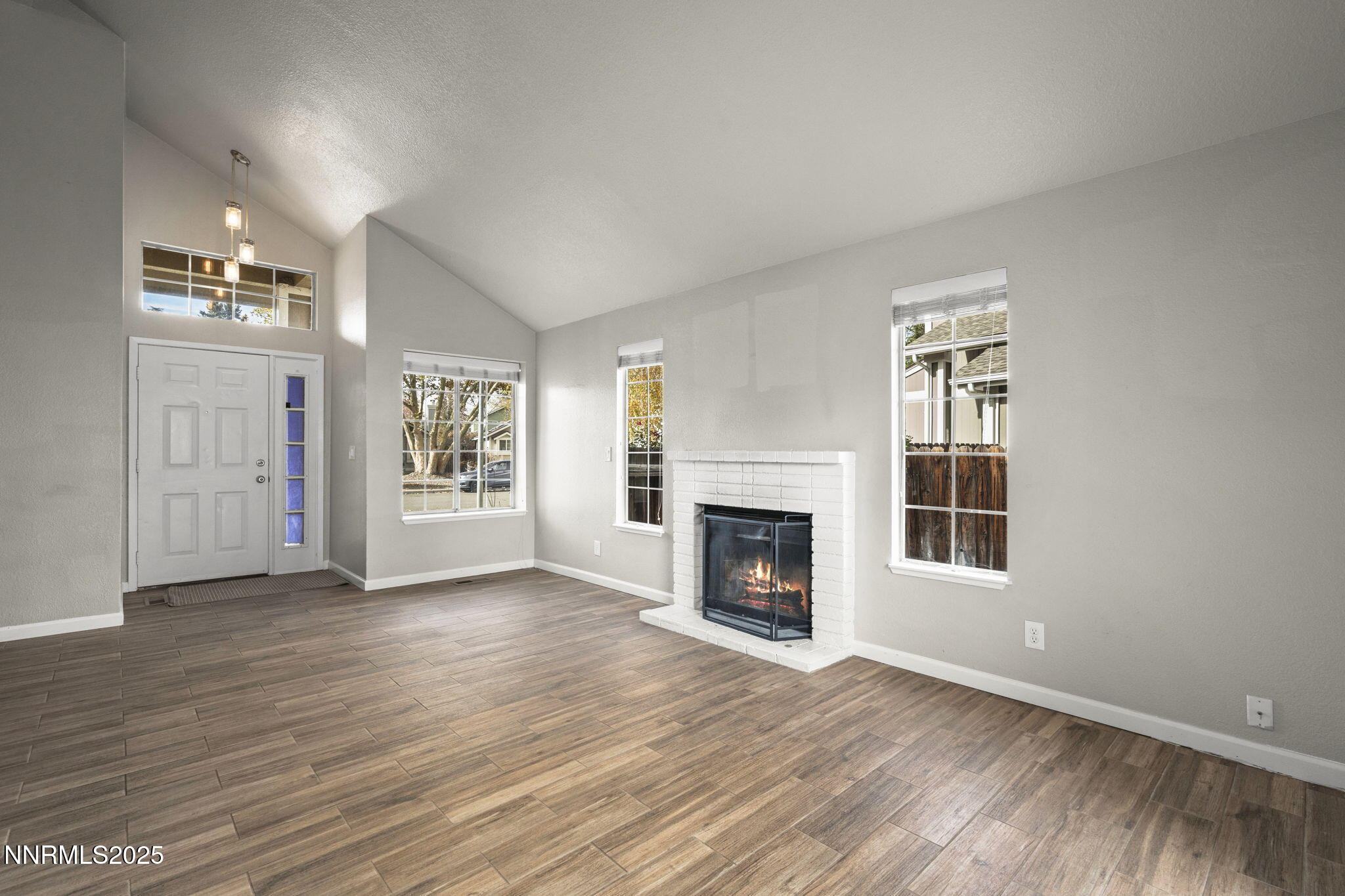 2768 Azuza Way Reno, NV 89502 - Photo 8 of 26 wooden floor fireplace and windows in an empty room