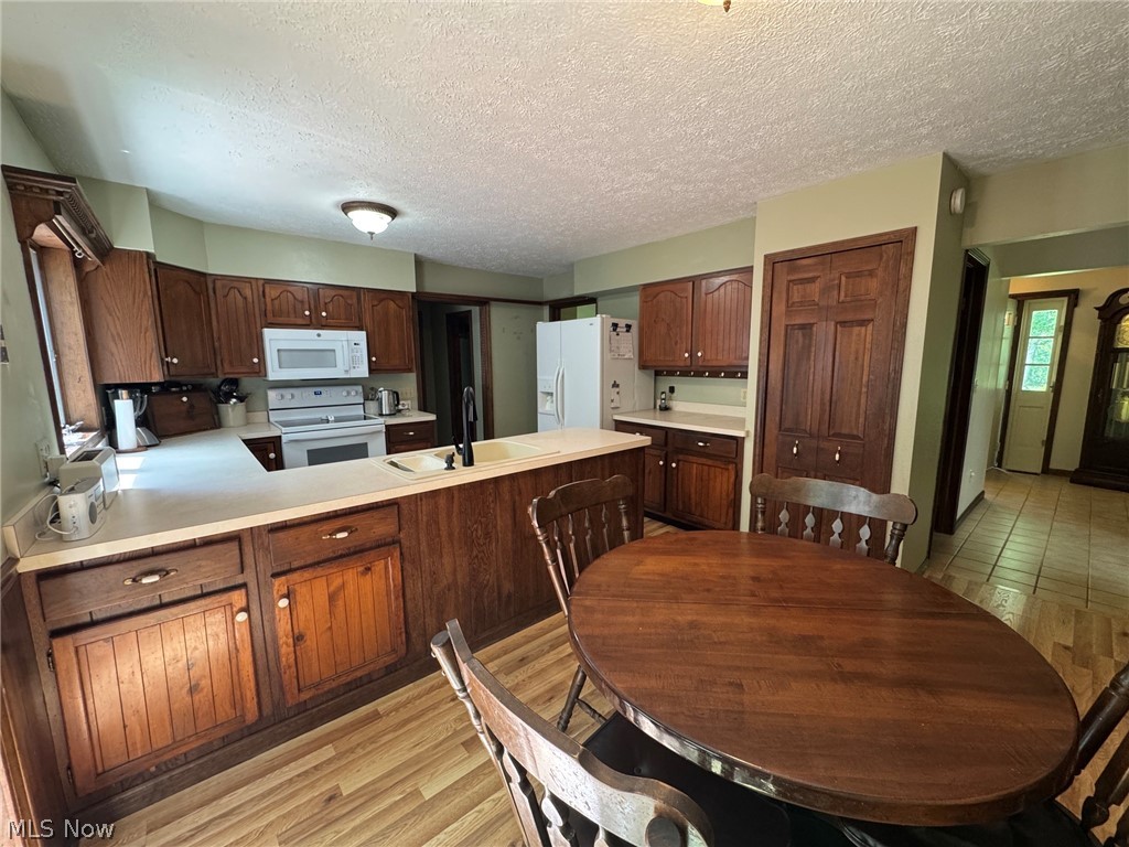 8201 Orchard Road Painesville, OH 44077 - Photo 12 of 45 Kitchen view featuring wood cabinetry and eating area