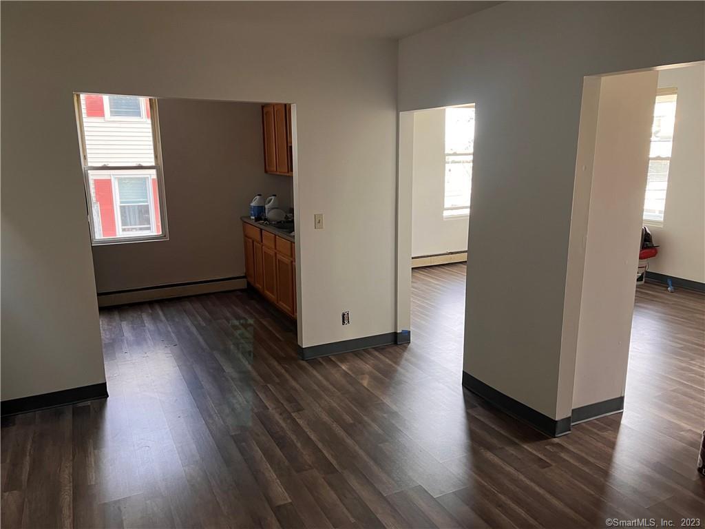 64 Merchants Avenue, Unit 66 Taftville, CT 06380 - Photo 1 of 1 an empty room with wooden floor and windows
