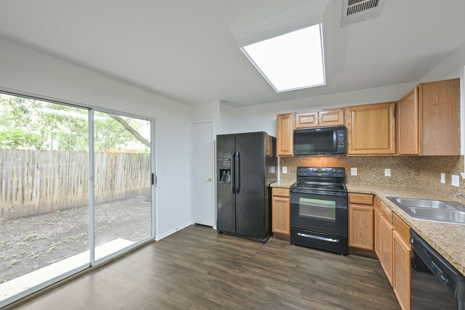 6733 Doyal Drive Austin, TX 78747 - Photo 18 of 28 A well-equipped kitchen space featuring an electric range and refrigerator, with ample countertop and cabinetry.