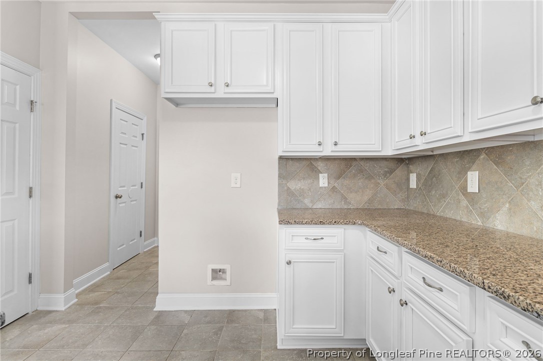 50 Huzzas Circle Cameron, NC 28326 - Photo 16 of 39 a view of cabinets and utility room
