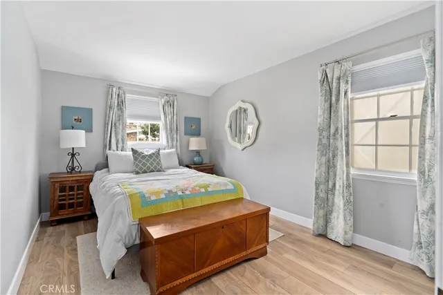 a bed sitting in a bedroom next to a window