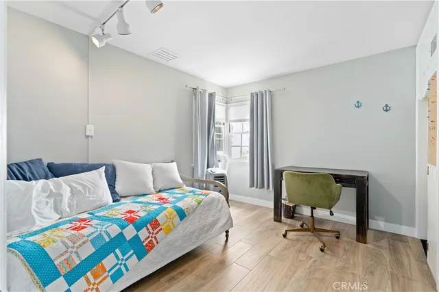 a bedroom with a bed and a chair