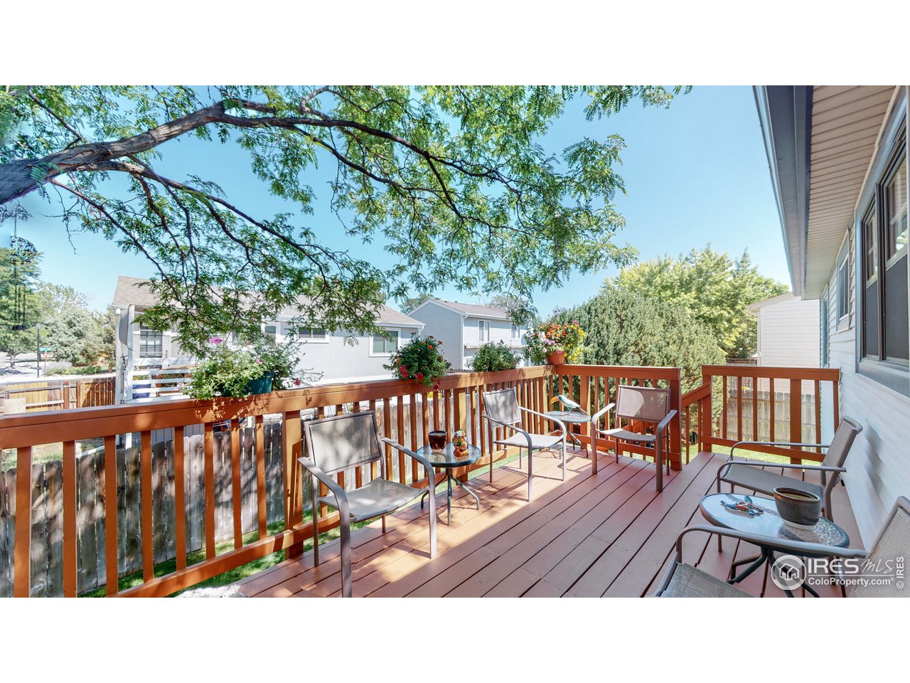 1554 Ervine Avenue Longmont, CO 80501 - Photo 12 of 31 a balcony with wooden floor and outdoor seating