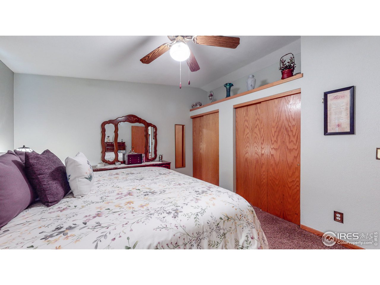 1554 Ervine Avenue Longmont, CO 80501 - Photo 13 of 31 a bed room with a bed and a large mirror